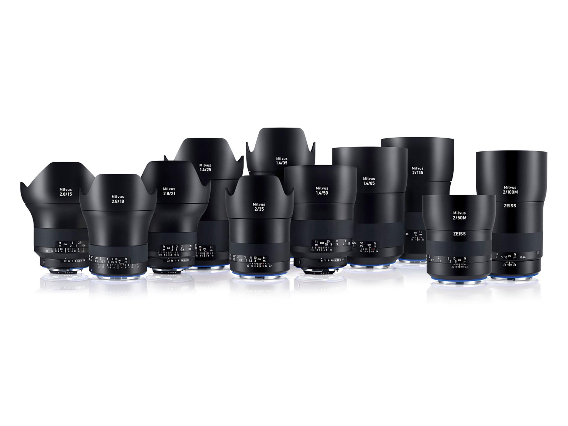 A lineup of various ZEISS camera lenses arranged in rows on a white background.