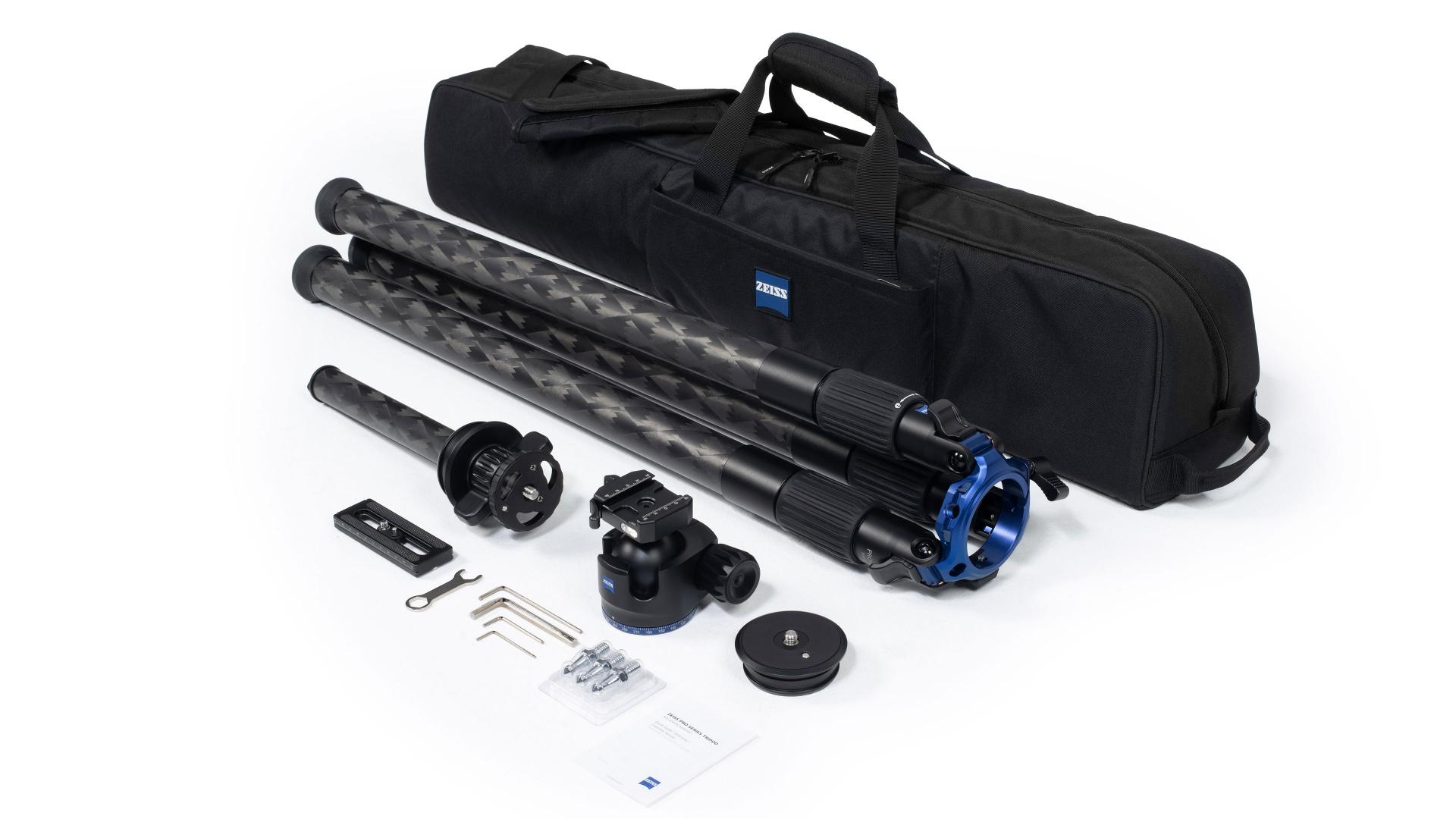 ZEISS tripod kit with carrying case, tripod, mounting accessories, tools, and instruction manuals laid out on a white background.