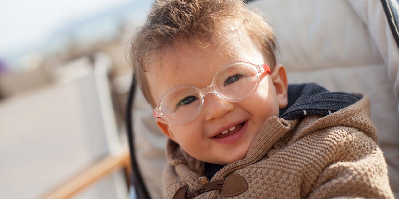 smiling baby with eyeglasses