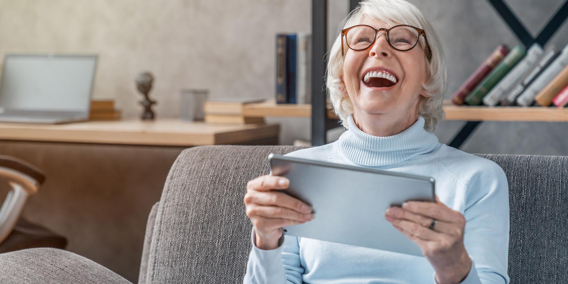 Happy delighted woman looking at a tablet device