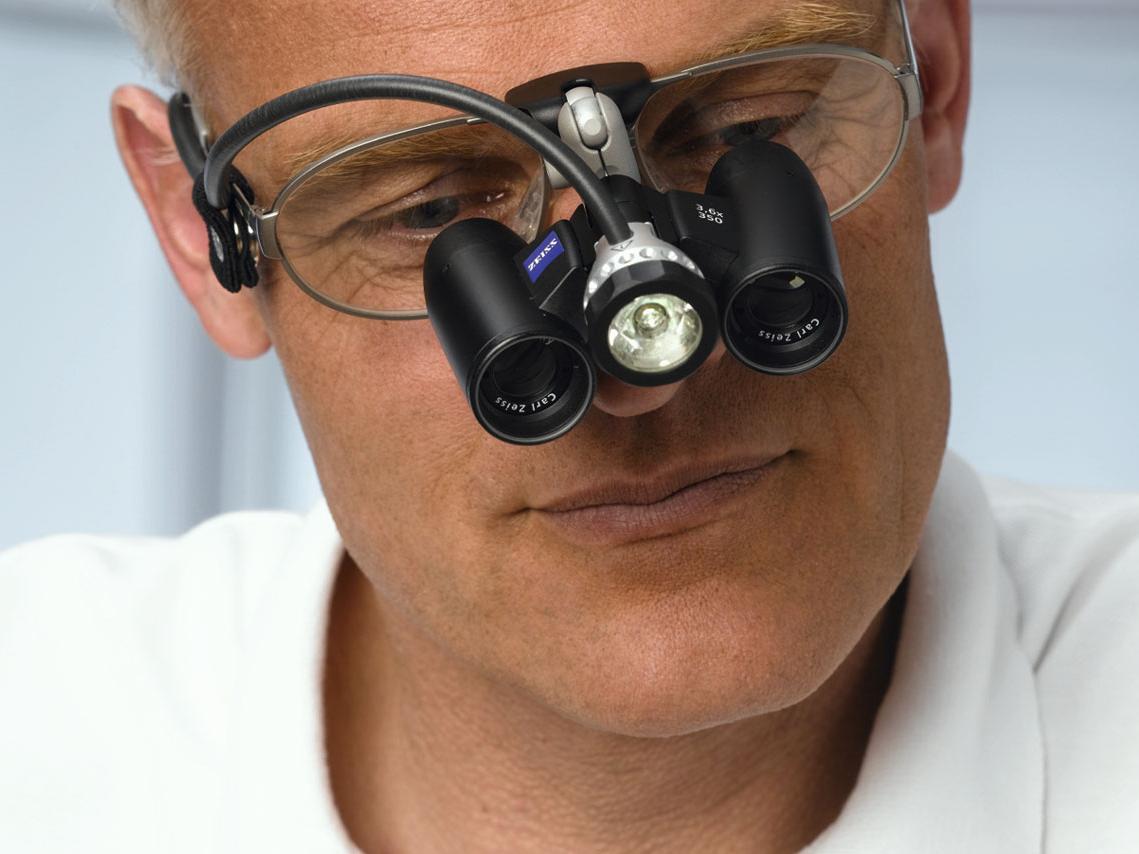 A man wears magnifying glasses.