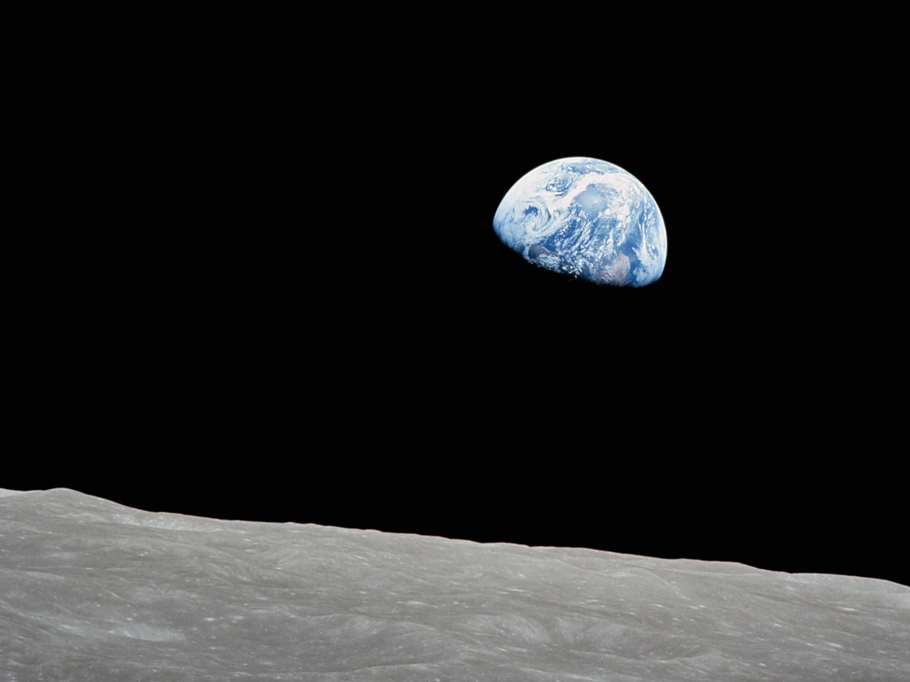 Perspective of standing on the moon surface and looking towards the earth.